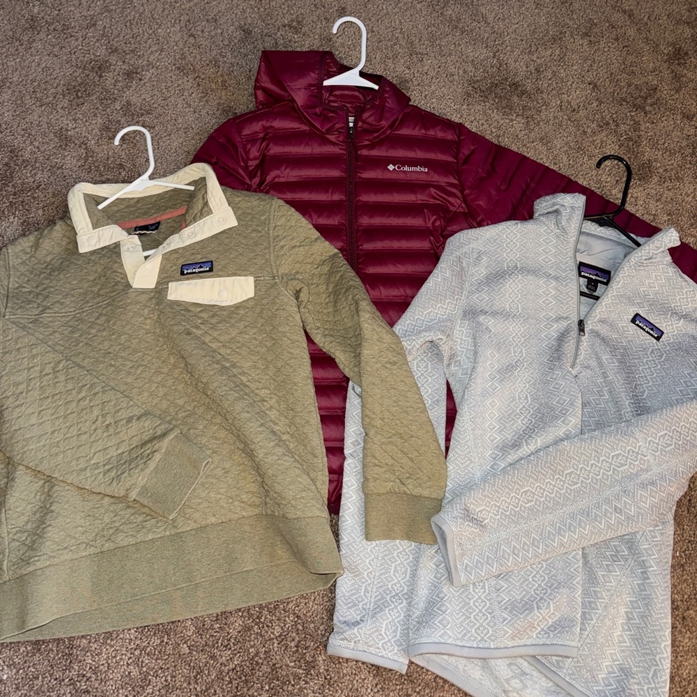 Two women’s Patagonia quarter zips and one Columbia puffer jacket
